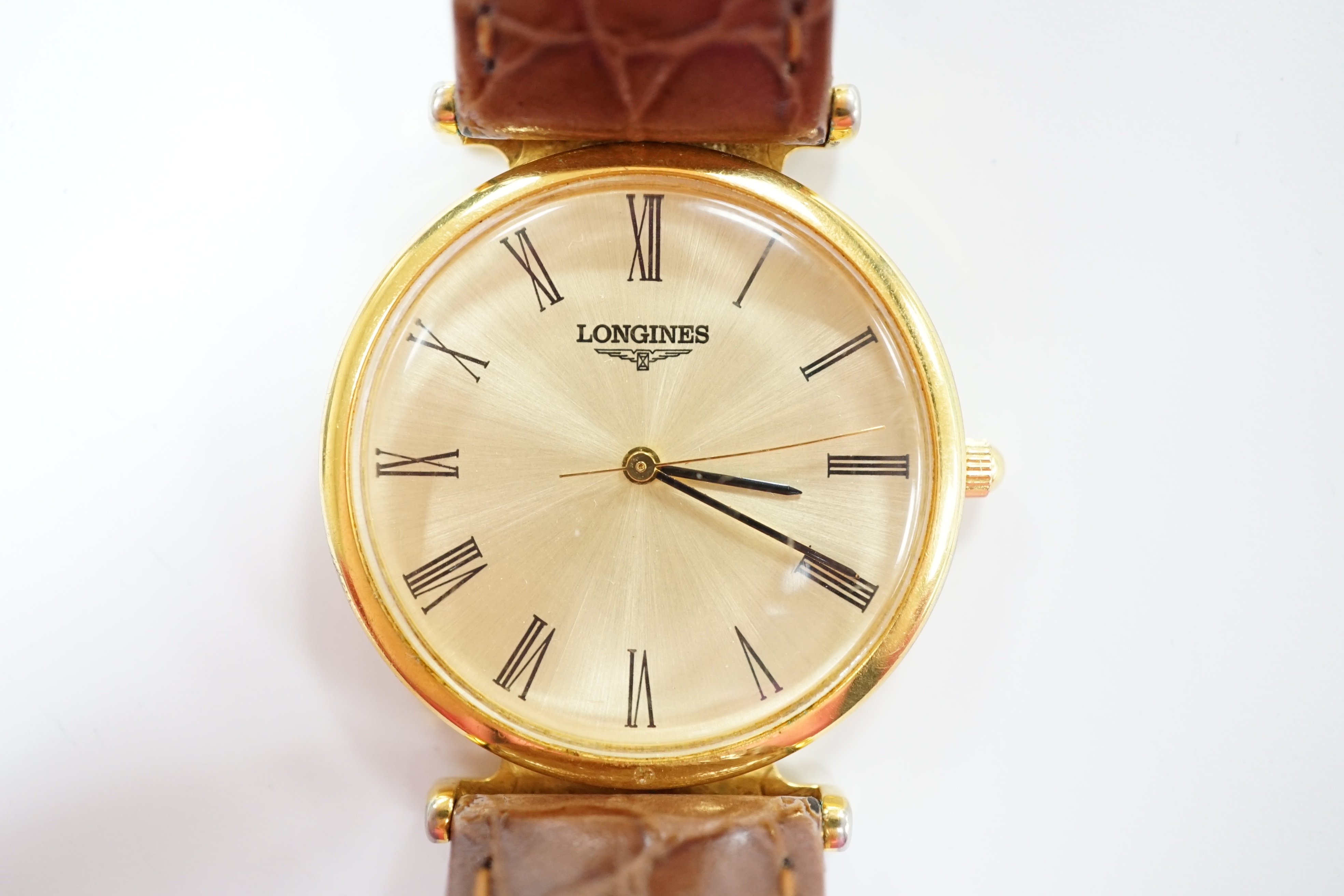 A gentleman's 24kt gold plated Longines quartz dress wrist watch, on associated leather strap.